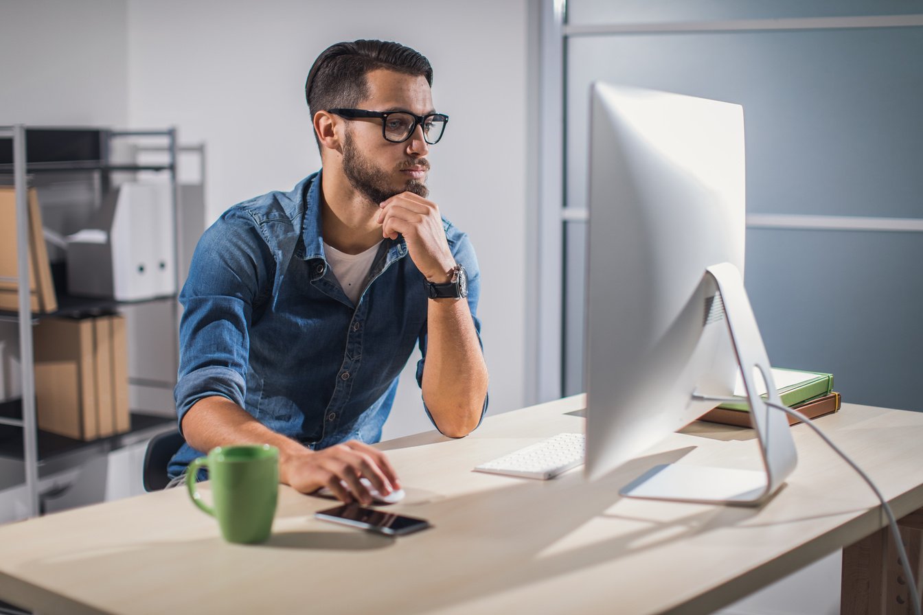 Man Using Computer at His Office