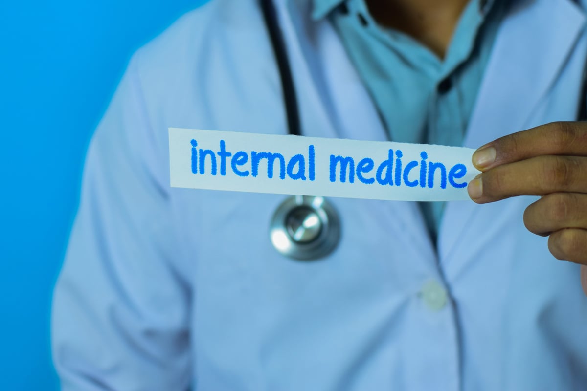 Doctor holding a card with text internal medicine.